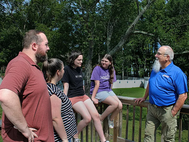 Rich talking with a family